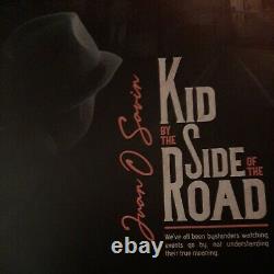 Kid by the side of the road. JFK JR EDITOR GEORGE MAGAZINE JUAN O SAVIN